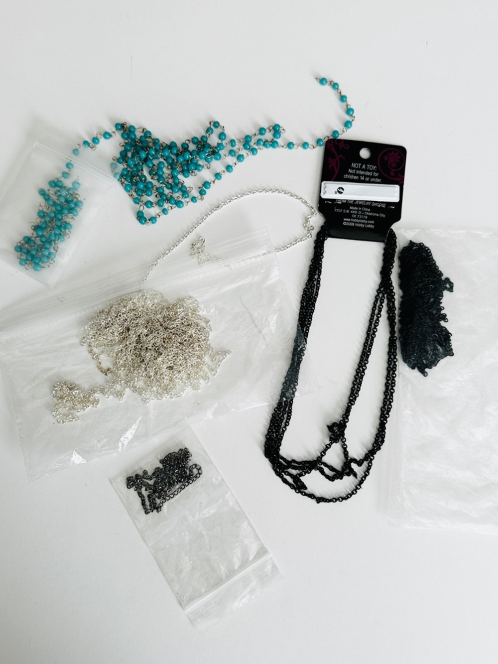 Lot #5 Assortment of jewelry crafting metal and beaded chains.